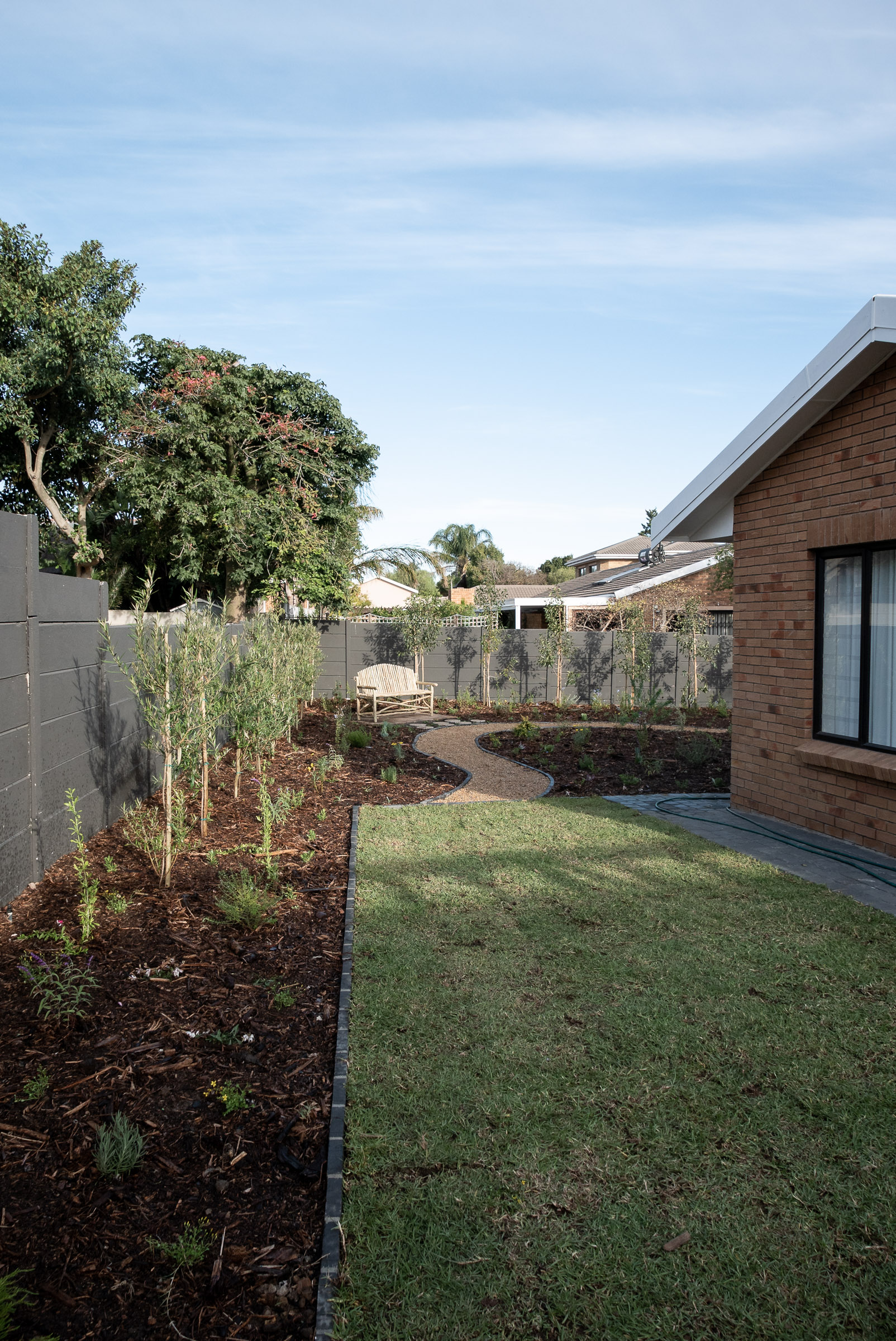 horizon-paving-welgelegen-walkways-side-path Side garden walkway connecting lawn and home with soft planting edges